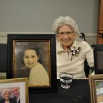 Resident Florence Spinelli poses with photos from her memory table